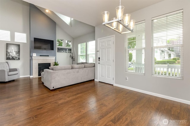 6409 Francis Ave SE, Auburn, WA 98092 - living room featuring a tiled fireplace, dark wood-style flooring, high vaulted ceiling, and a chandelier