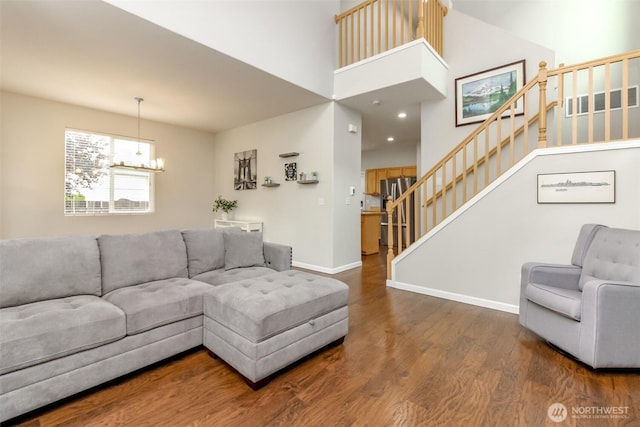 6409 Francis Ave SE, Auburn, WA 98092 - living area with wood finished floors, stairs, a chandelier, and a towering ceiling