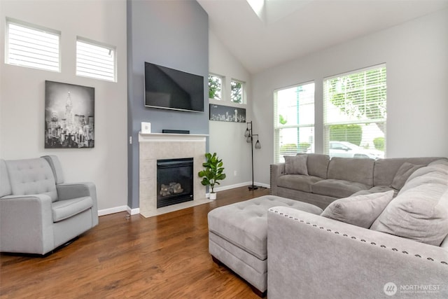 6409 Francis Ave SE, Auburn, WA 98092 - living room featuring high vaulted ceiling, wood finished floors, and a tile fireplace