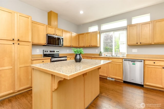 6409 Francis Ave SE, Auburn, WA 98092 - kitchen with stainless steel appliances, light brown cabinetry, light countertops, recessed lighting, and a center island