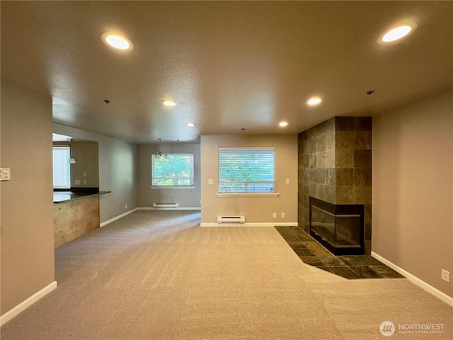 1626 Grant Ave S Unit E202, Renton, WA 98055 - unfurnished living room with baseboard heating, carpet, recessed lighting, and a tile fireplace