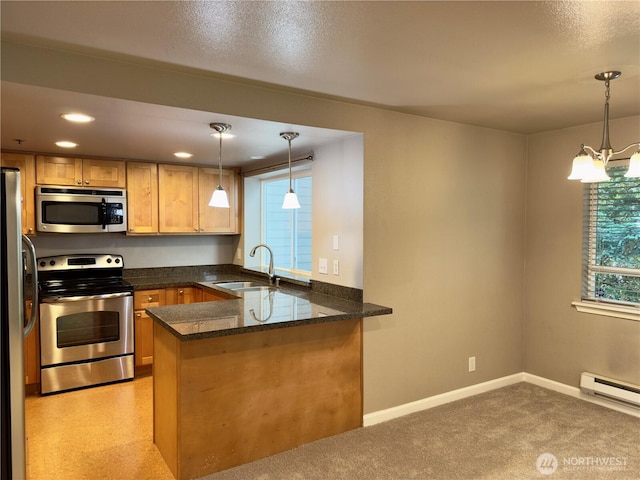 1626 Grant Ave S Unit E202, Renton, WA 98055 - kitchen featuring stainless steel appliances, a peninsula, a chandelier, dark stone counters, and pendant lighting