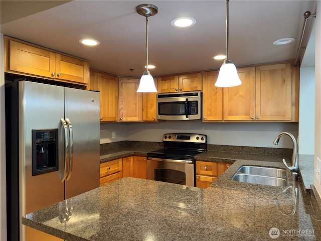 1626 Grant Ave S Unit E202, Renton, WA 98055 - kitchen featuring appliances with stainless steel finishes, decorative light fixtures, recessed lighting, a peninsula, and dark stone countertops