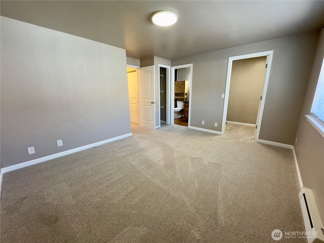 1626 Grant Ave S Unit E202, Renton, WA 98055 - unfurnished bedroom featuring a baseboard heating unit, light carpet, and connected bathroom