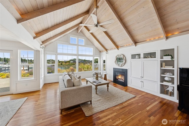 882 Shoshone Dr, La Conner, WA 98257 - living room with a wood ceiling with exposed beams, a fireplace with flush hearth, healthy amount of natural light, wood finished floors, and high vaulted ceiling