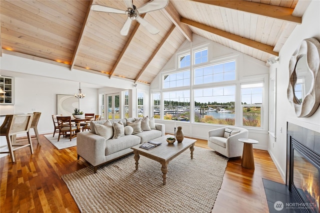 882 Shoshone Dr, La Conner, WA 98257 - living room with a fireplace with flush hearth, wood finished floors, a wood ceiling with exposed beams, a ceiling fan, and high vaulted ceiling