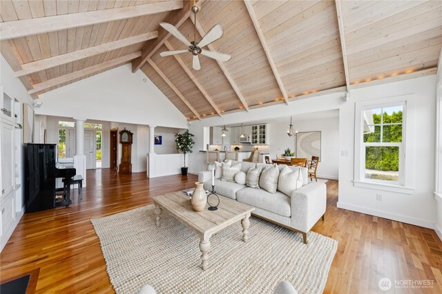 882 Shoshone Dr, La Conner, WA 98257 - living area with a wooden ceiling with exposed beams, light wood-style flooring, plenty of natural light, a ceiling fan, and decorative columns