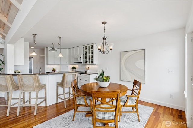 882 Shoshone Dr, La Conner, WA 98257 - dining space with light wood finished floors and a chandelier