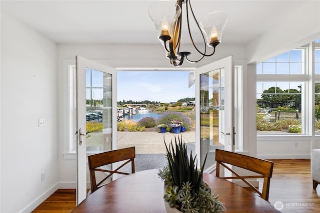 882 Shoshone Dr, La Conner, WA 98257 - dining area featuring french doors, a chandelier, and plenty of natural light