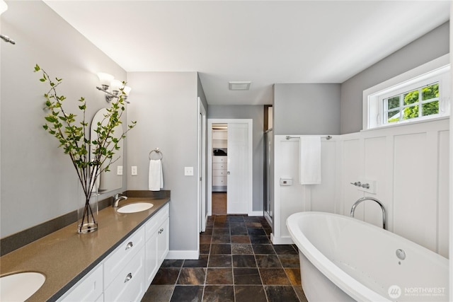 882 Shoshone Dr, La Conner, WA 98257 - full bathroom featuring stone finish flooring, double vanity, a freestanding bath, and a shower stall