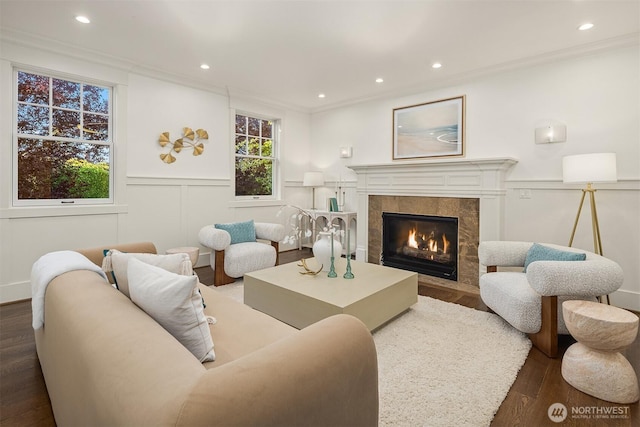 3202 Hunter Blvd S, Seattle, WA 98144 - living room featuring wood finished floors, a high end fireplace, crown molding, recessed lighting, and a decorative wall
