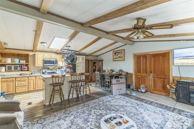 451 Serpentine Ave, Sequim, WA 98382 - living room with light wood-type flooring, ceiling fan, and wood walls