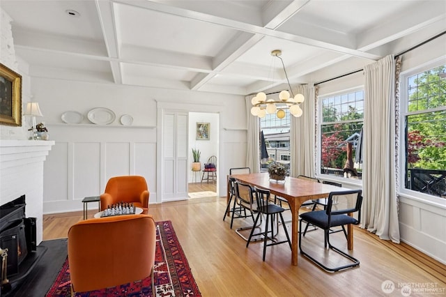 2233 2nd Ave W, Seattle, WA 98119 - dining area featuring a decorative wall, coffered ceiling, light wood-style flooring, a chandelier, and beam ceiling