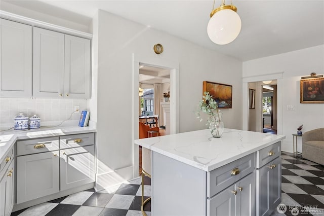 2233 2nd Ave W, Seattle, WA 98119 - kitchen featuring tile patterned floors, gray cabinetry, a center island, and healthy amount of natural light