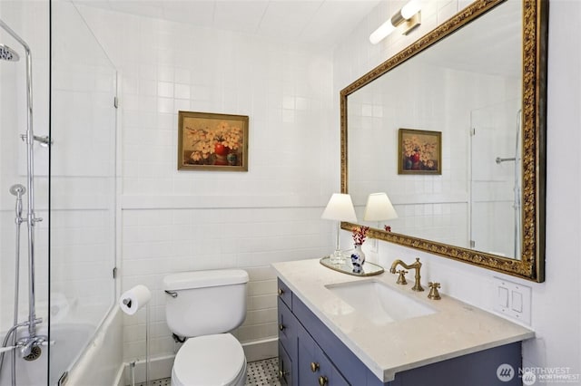 2233 2nd Ave W, Seattle, WA 98119 - bathroom featuring tile walls, vanity, and bath / shower combo with glass door