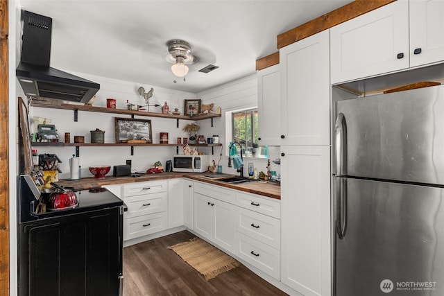 174 Skinner Rd, Chehalis, WA 98532 - kitchen with freestanding refrigerator, electric range, ventilation hood, white microwave, and butcher block countertops