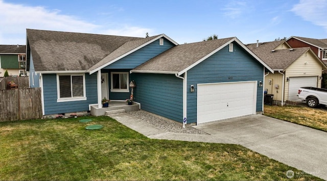 16223 Birkland St SE, Yelm, WA 98597 - view of front facade featuring a garage, driveway, and a shingled roof