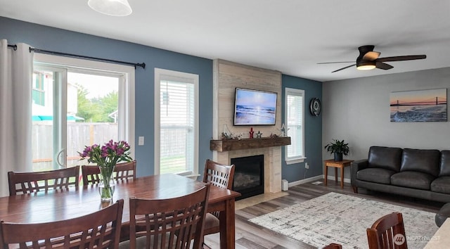 16223 Birkland St SE, Yelm, WA 98597 - dining room with wood finished floors, a fireplace, and ceiling fan