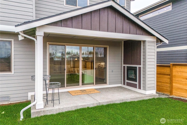 20625 153rd St E, Bonney Lake, WA 98391 - view of exterior entry with a patio and board and batten siding