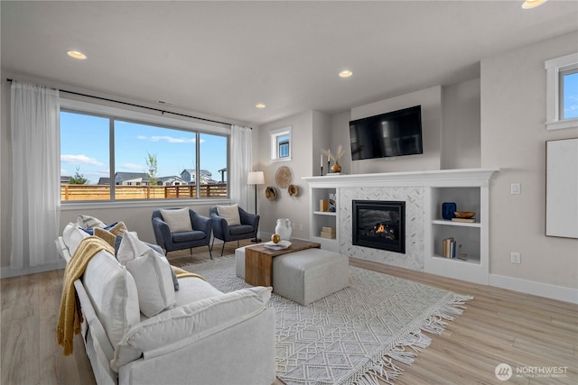 20625 153rd St E, Bonney Lake, WA 98391 - living area featuring wood finished floors, a fireplace, recessed lighting, and built in features