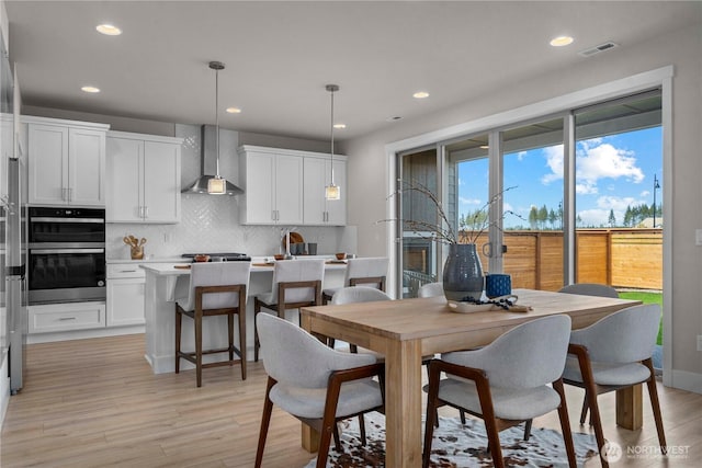 20625 153rd St E, Bonney Lake, WA 98391 - dining space featuring light wood finished floors and recessed lighting