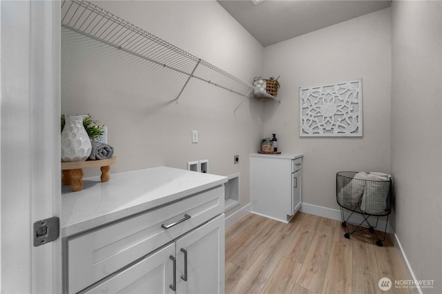 20625 153rd St E, Bonney Lake, WA 98391 - laundry room with hookup for an electric dryer, cabinet space, light wood-style flooring, and hookup for a washing machine