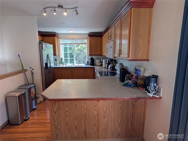 15730 91st Way SE, Yelm, WA 98597 - kitchen with electric range oven, white microwave, stainless steel fridge with ice dispenser, a peninsula, and light wood-type flooring