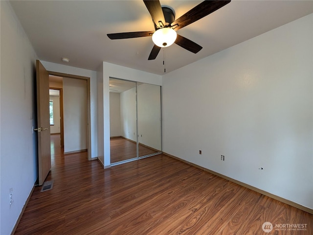 15730 91st Way SE, Yelm, WA 98597 - unfurnished bedroom featuring wood finished floors, a closet, and ceiling fan