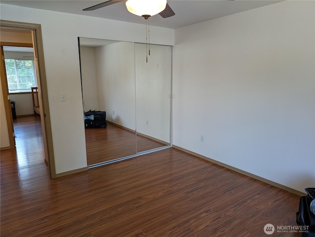 15730 91st Way SE, Yelm, WA 98597 - unfurnished bedroom featuring wood finished floors, a closet, and a ceiling fan