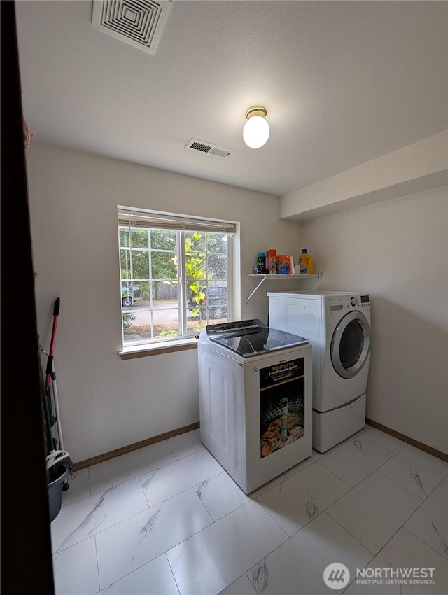 15730 91st Way SE, Yelm, WA 98597 - laundry area featuring washer and clothes dryer and light marble finish flooring