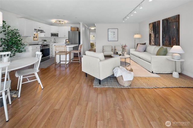 2501 Canterbury Ln E Unit 221, Seattle, WA 98112 - living room with light wood-style flooring and track lighting
