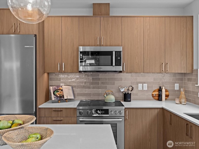 9015 Dibble Ave NW Unit B, Seattle, WA 98117 - kitchen featuring appliances with stainless steel finishes, light countertops, decorative backsplash, and modern cabinets