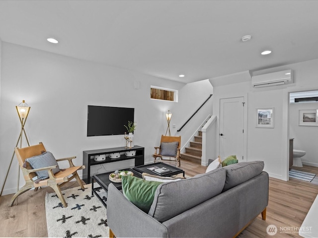9015 Dibble Ave NW Unit B, Seattle, WA 98117 - living room featuring a wall mounted air conditioner, stairway, recessed lighting, and wood finished floors