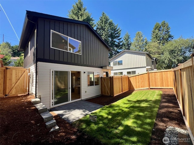 9015 Dibble Ave NW Unit B, Seattle, WA 98117 - rear view of property with board and batten siding, a fenced backyard, a gate, and a patio