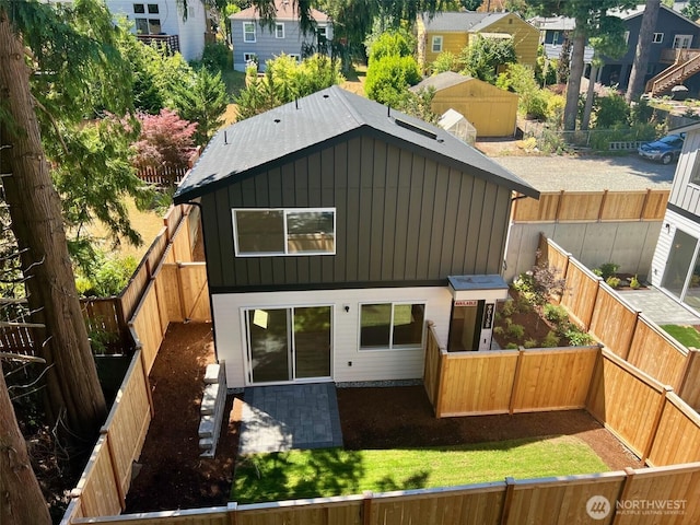9015 Dibble Ave NW Unit B, Seattle, WA 98117 - back of property with board and batten siding and a fenced backyard