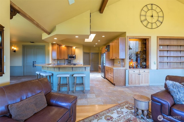 822 E Oak St, Sequim, WA 98382 - kitchen featuring open floor plan, stainless steel appliances, built in features, a peninsula, and beamed ceiling