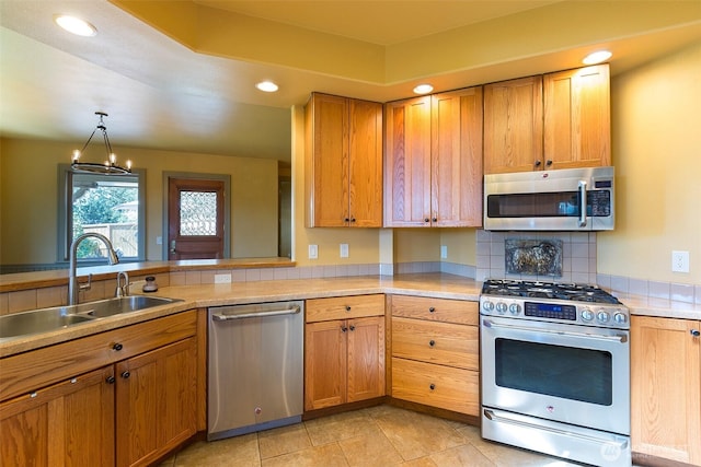 822 E Oak St, Sequim, WA 98382 - kitchen with stainless steel appliances, light countertops, backsplash, recessed lighting, and decorative light fixtures