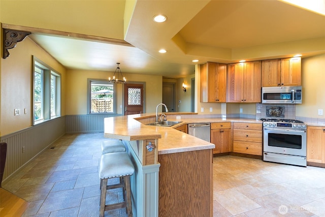 822 E Oak St, Sequim, WA 98382 - kitchen with appliances with stainless steel finishes, a peninsula, a chandelier, light countertops, and recessed lighting