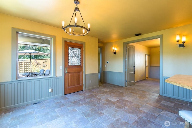 822 E Oak St, Sequim, WA 98382 - entrance foyer featuring wainscoting, a chandelier, and stone tile floors
