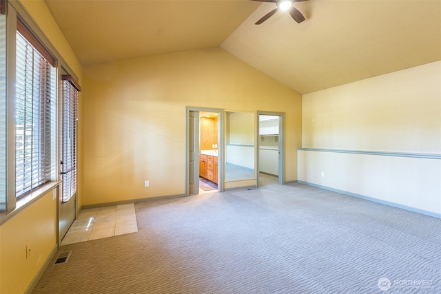 822 E Oak St, Sequim, WA 98382 - unfurnished bedroom featuring lofted ceiling, multiple windows, light colored carpet, a spacious closet, and a ceiling fan
