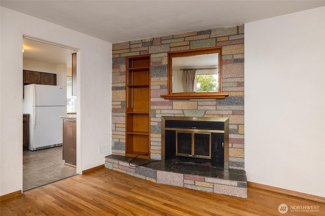 1411 38th St, Anacortes, WA 98221 - unfurnished living room featuring a stone fireplace and wood finished floors