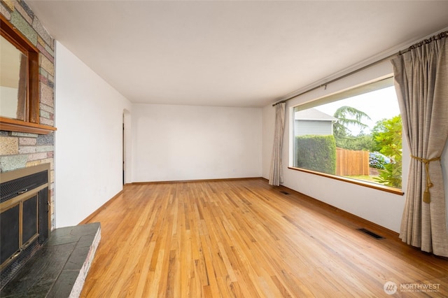 1411 38th St, Anacortes, WA 98221 - unfurnished living room with a fireplace and light wood-style flooring