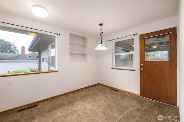 1411 38th St, Anacortes, WA 98221 - unfurnished dining area with baseboards and built in shelves
