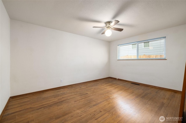 1411 38th St, Anacortes, WA 98221 - empty room with a ceiling fan and wood finished floors