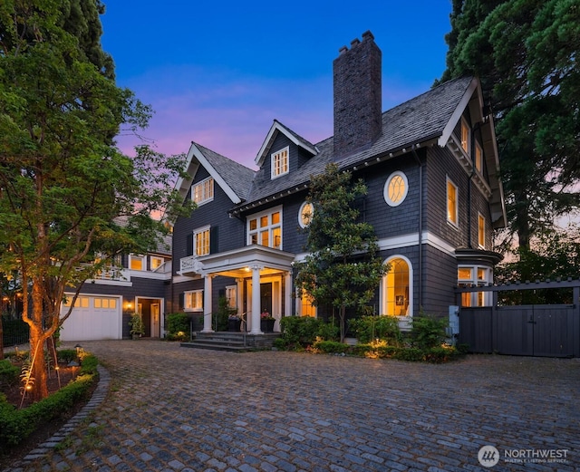 1617 Federal Ave E, Seattle, WA 98102 - shingle-style home featuring a chimney, a gate, decorative driveway, a garage, and a porch