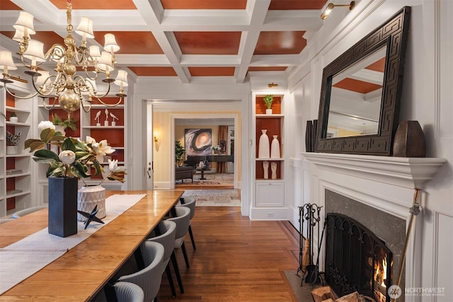 1617 Federal Ave E, Seattle, WA 98102 - dining space with a fireplace, a chandelier, wood finished floors, beamed ceiling, and built in shelves