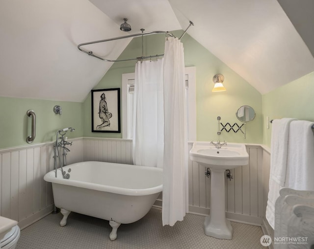1617 Federal Ave E, Seattle, WA 98102 - bathroom featuring lofted ceiling, wainscoting, a freestanding tub, and curtained shower