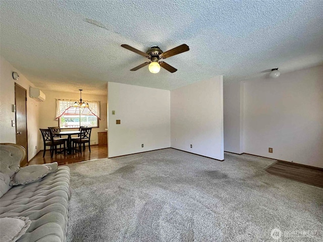 798 Division Ave, Morton, WA 98356 - unfurnished living room featuring a wall mounted air conditioner, a textured ceiling, carpet flooring, a ceiling fan, and a chandelier