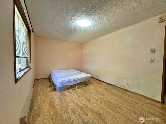 798 Division Ave, Morton, WA 98356 - unfurnished bedroom featuring a textured ceiling and wood finished floors