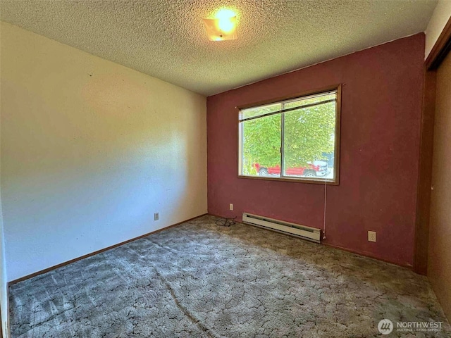 798 Division Ave, Morton, WA 98356 - unfurnished room featuring a baseboard heating unit, carpet floors, and a textured ceiling